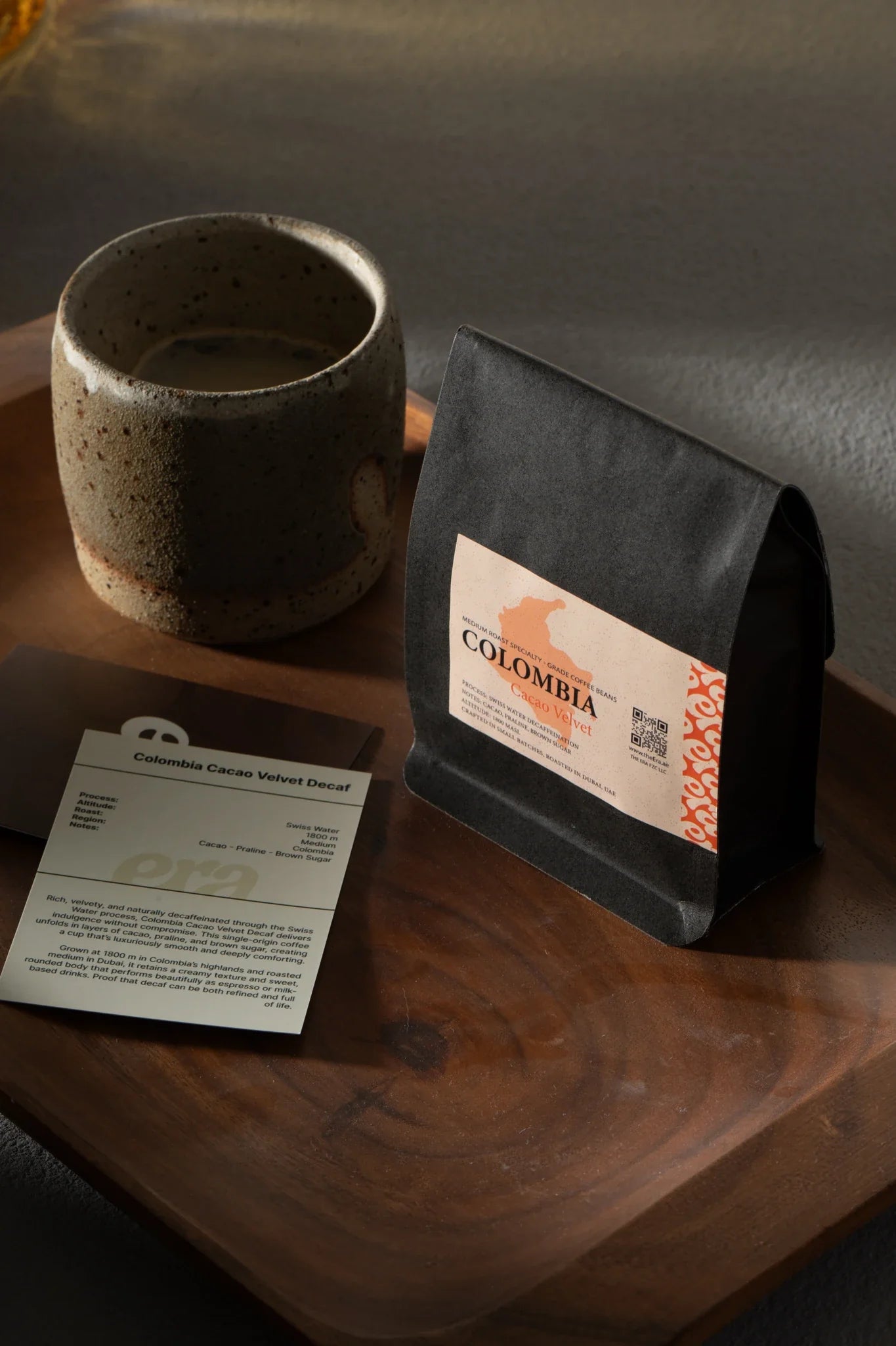 Era Colombia Cacao Velvet specialty coffee bag with ceramic cup on a wooden tray