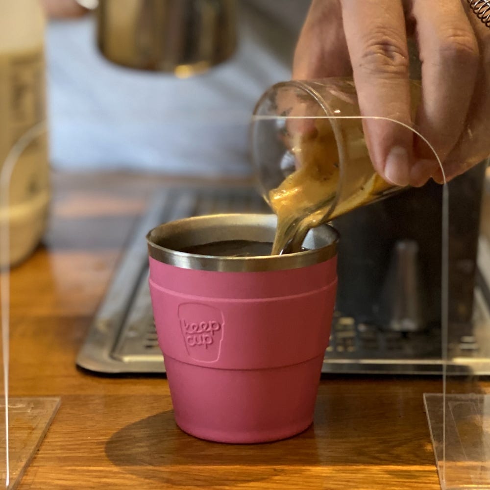 Barista pouring espresso into a KeepCup Insulated QuickSip Espresso Cup 177ml in Rose
