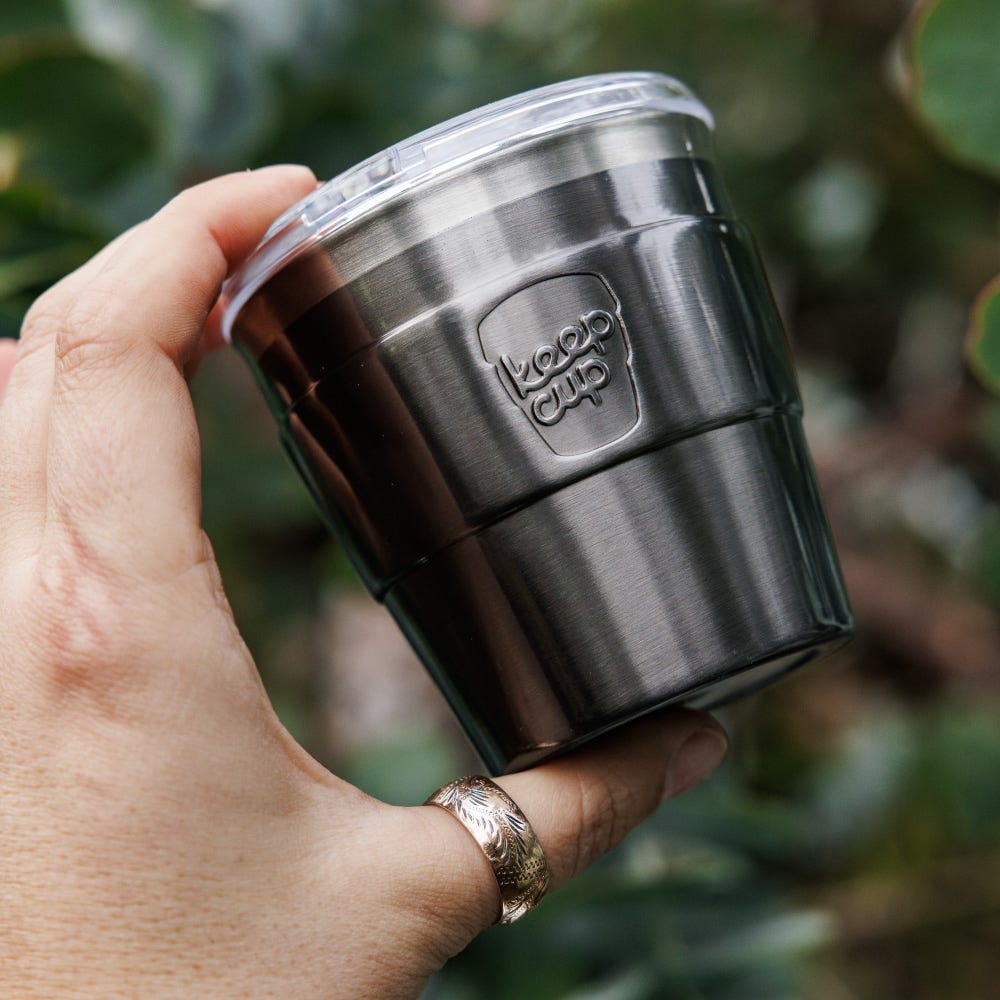 Hand holding a KeepCup Insulated QuickSip Espresso Cup 177ml in Nitro