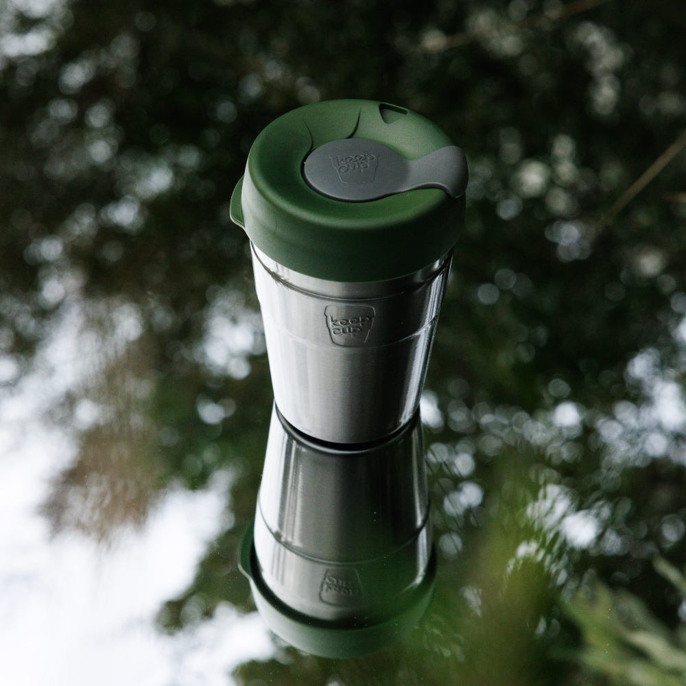 KeepCup Thermal 340ml in Pine from above on a reflective surface with leaves