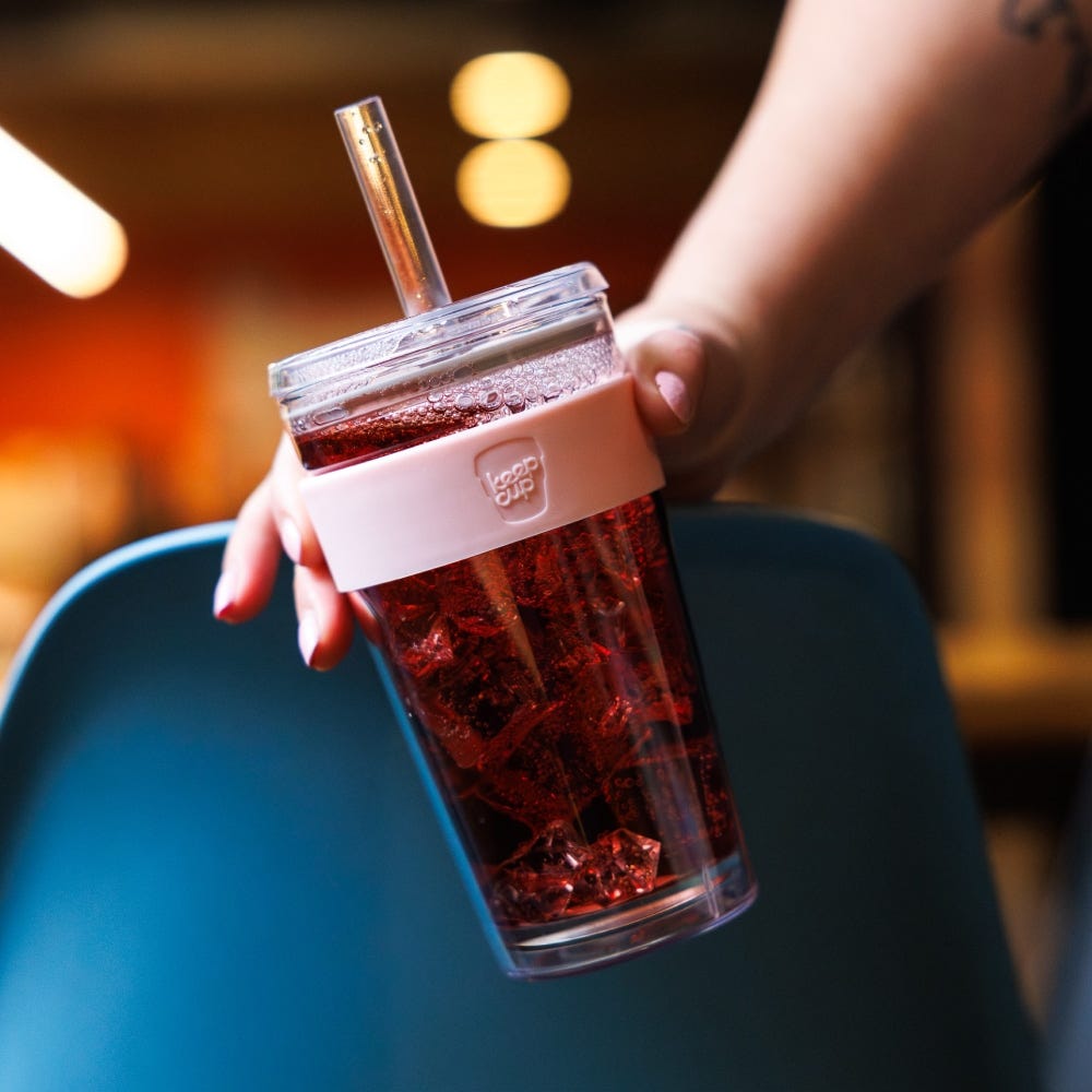 Hand holding a KeepCup Cold Cup Longplay Boba 454ml in Pashmak filled with an iced drink