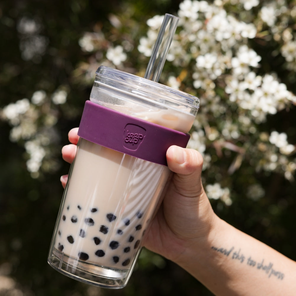 Hand holding a KeepCup Cold Cup Longplay Boba 454ml in Merlot filled with bubble tea