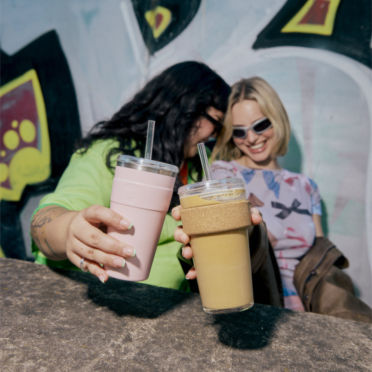 Two friends toasting with KeepCup Cold Cup Cork cups