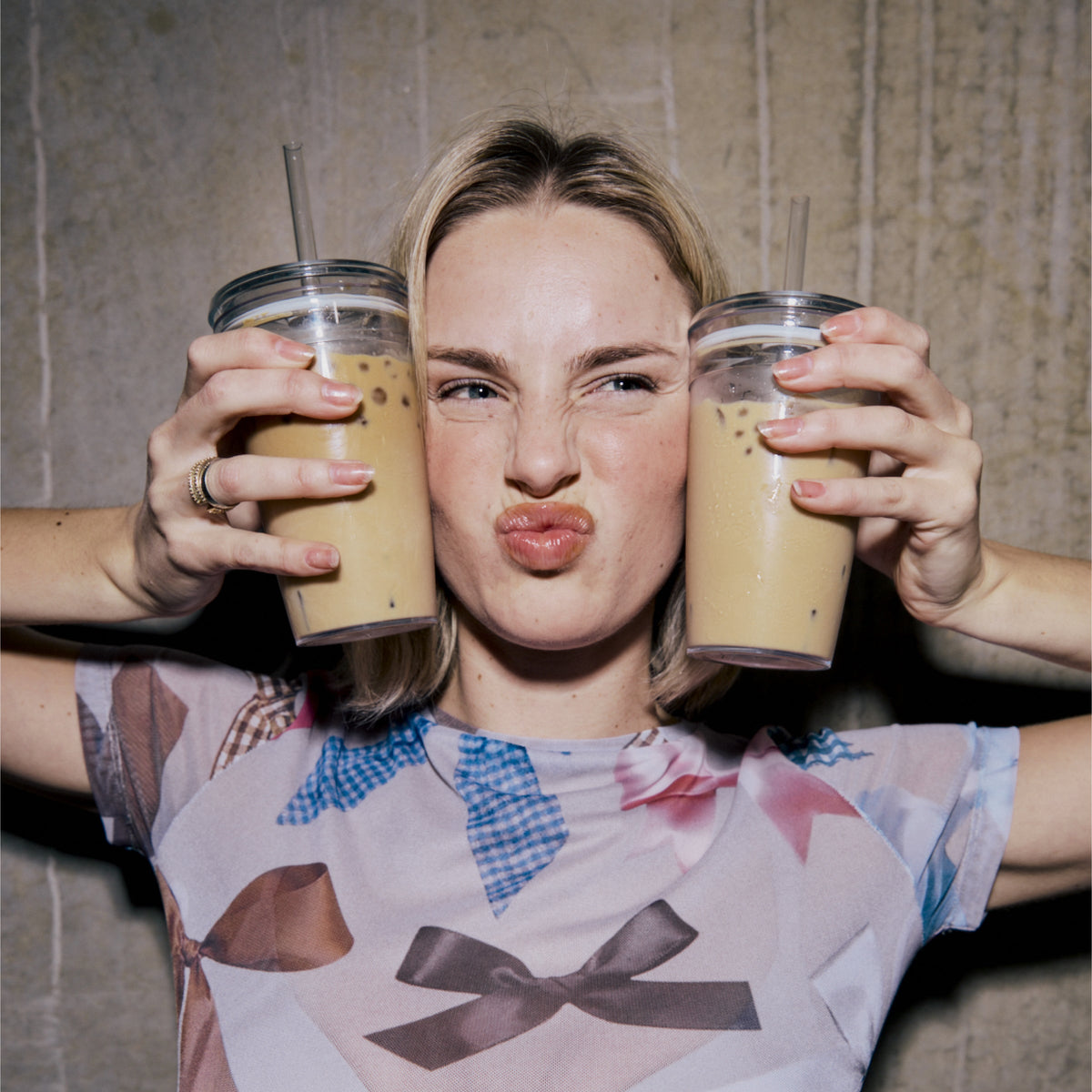 Woman holding two KeepCup Cold Cup Original 454ml cups filled with iced coffee