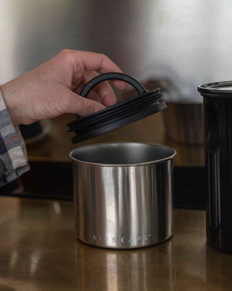 Pressing the Airscape plunger lid to push air out