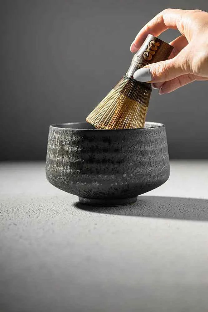 Whisking matcha with Era dark bamboo chasen