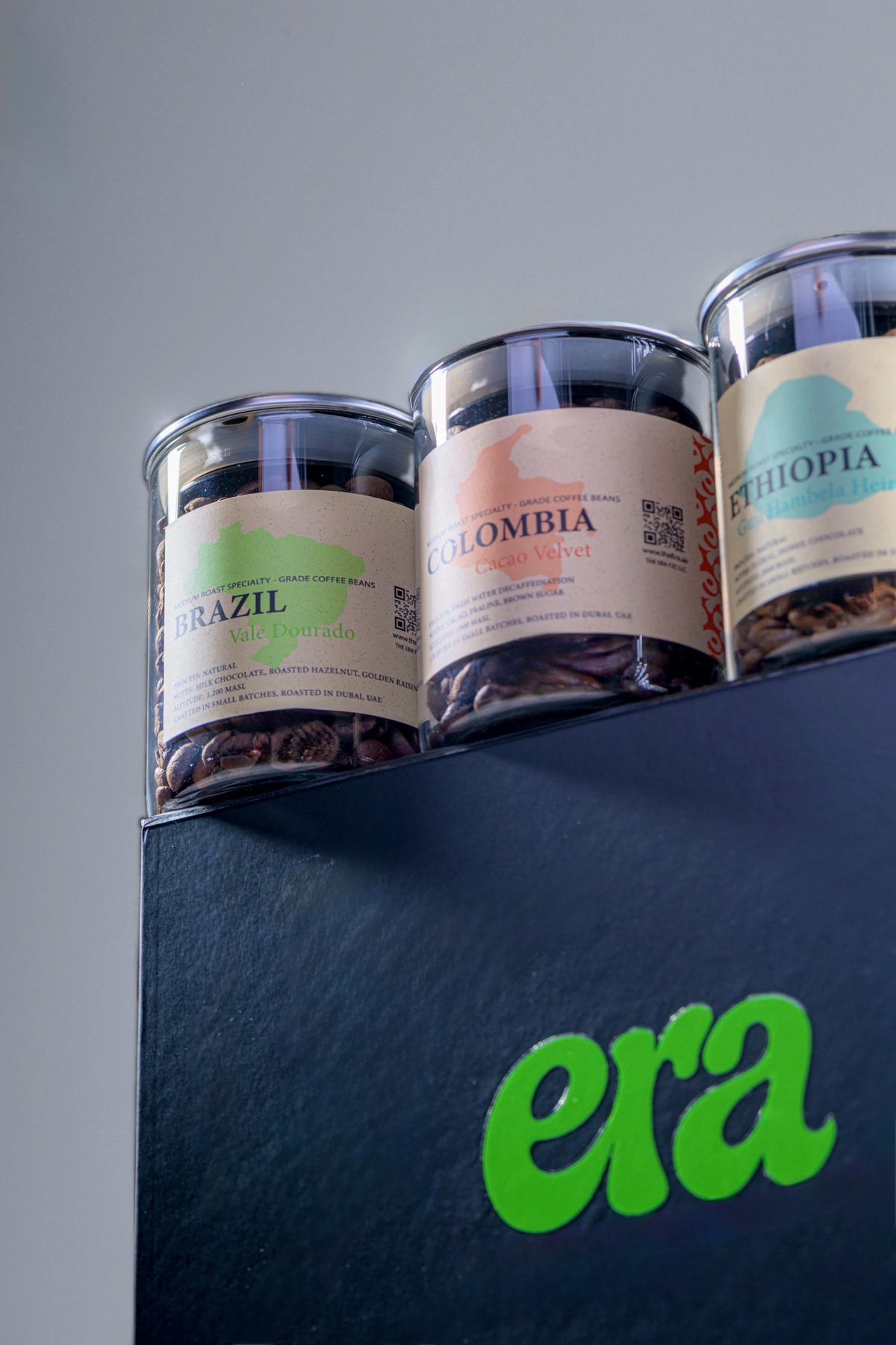 Era beans gift box glass jars close-up with Brazil, Colombia, and Ethiopia labels on a black era box