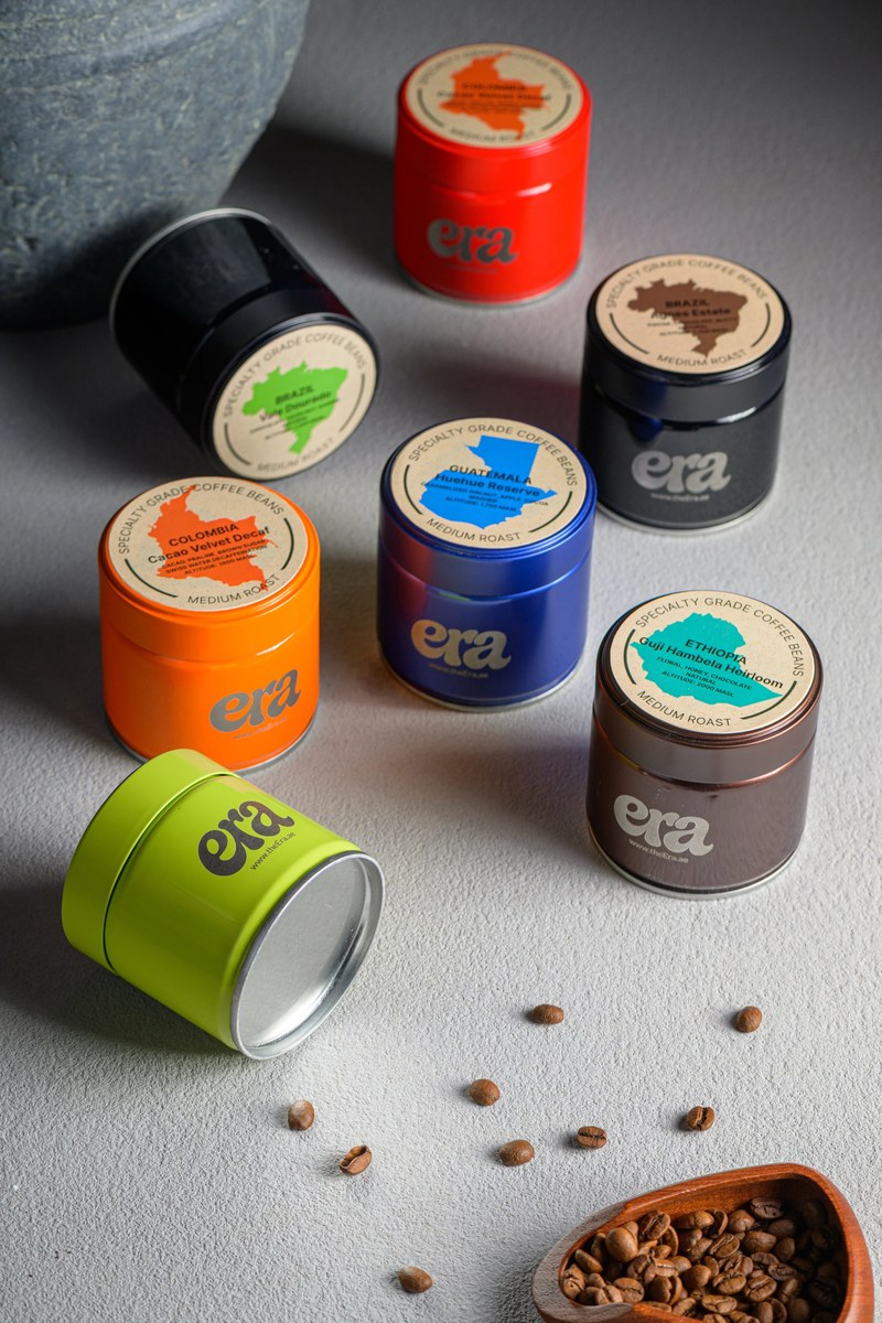 Era specialty coffee bean tins in seven colors with origin labels