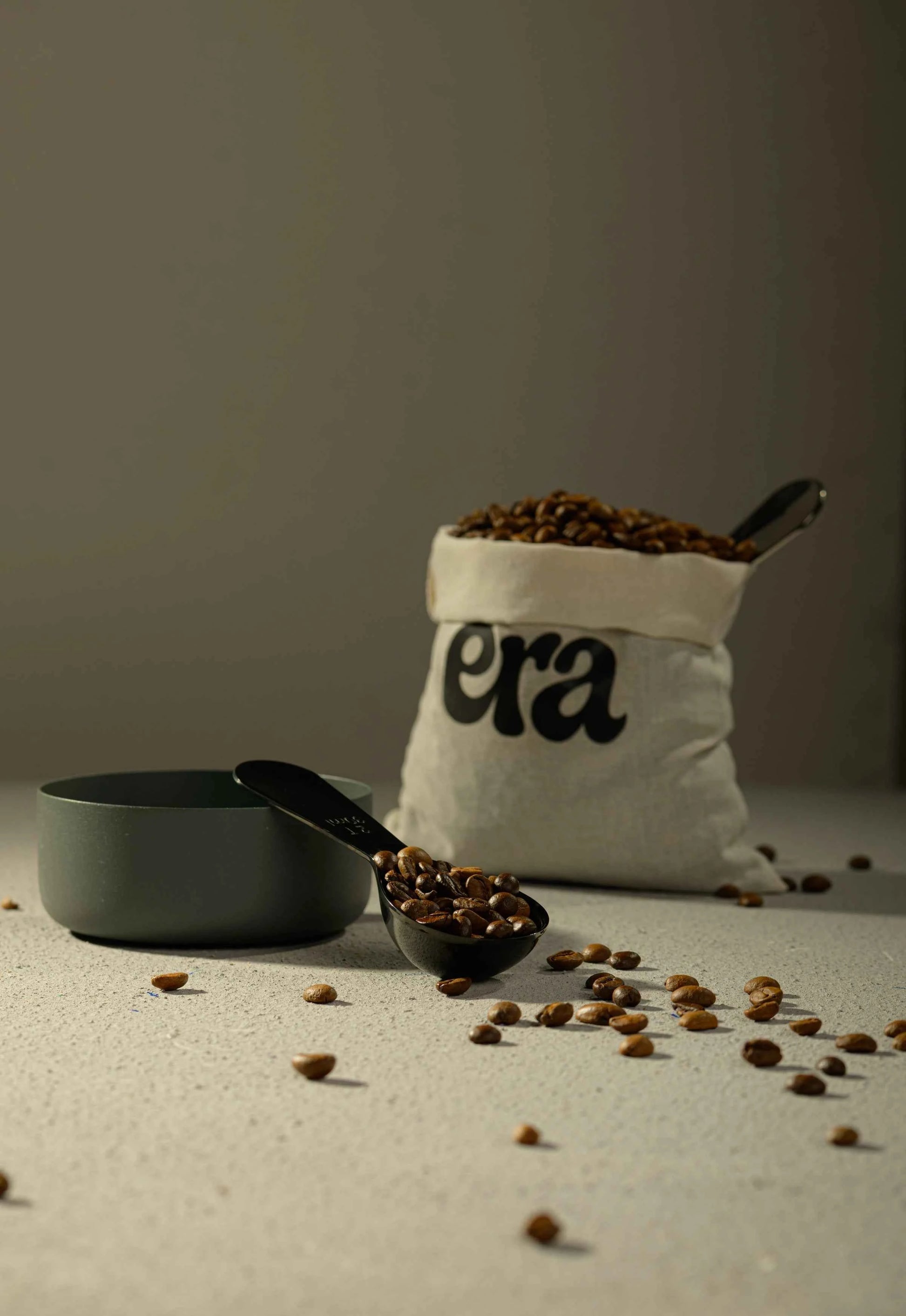 Era coffee scoop beside a bag of freshly roasted beans
