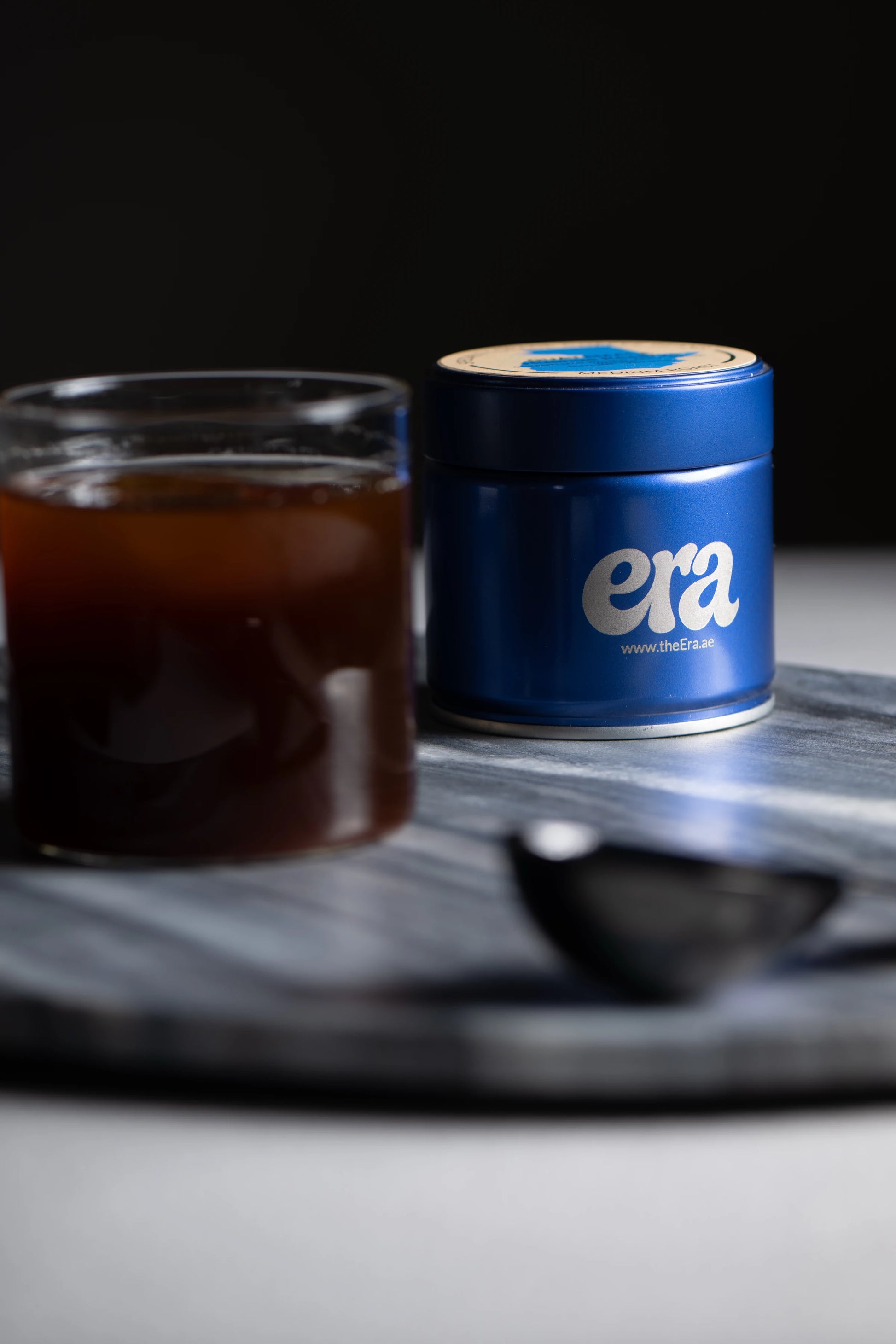 Blue era engraved coffee tin with a brewed cup of coffee