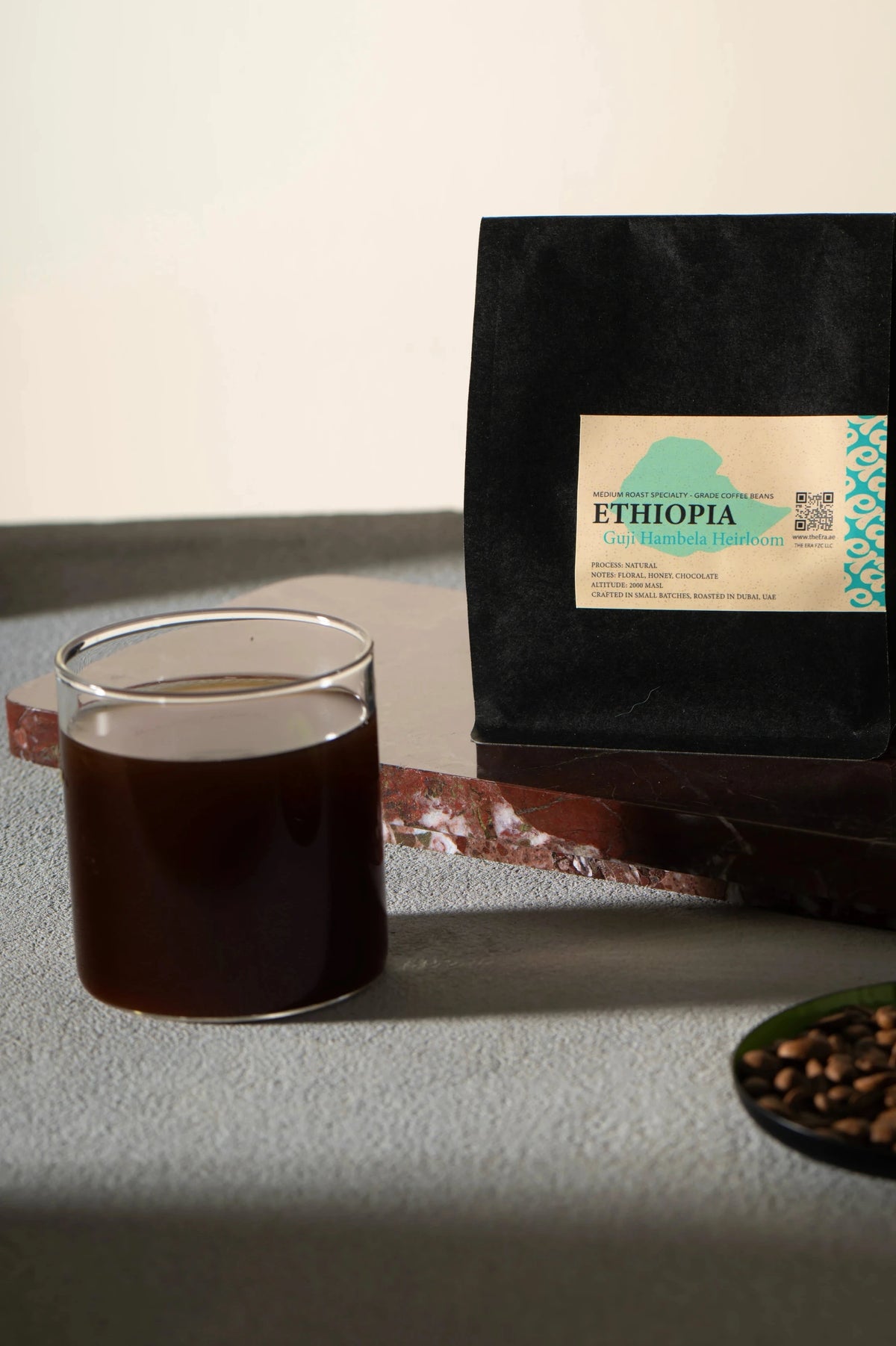 Era Ethiopia Guji Hambela Heirloom coffee bag with a brewed black cup
