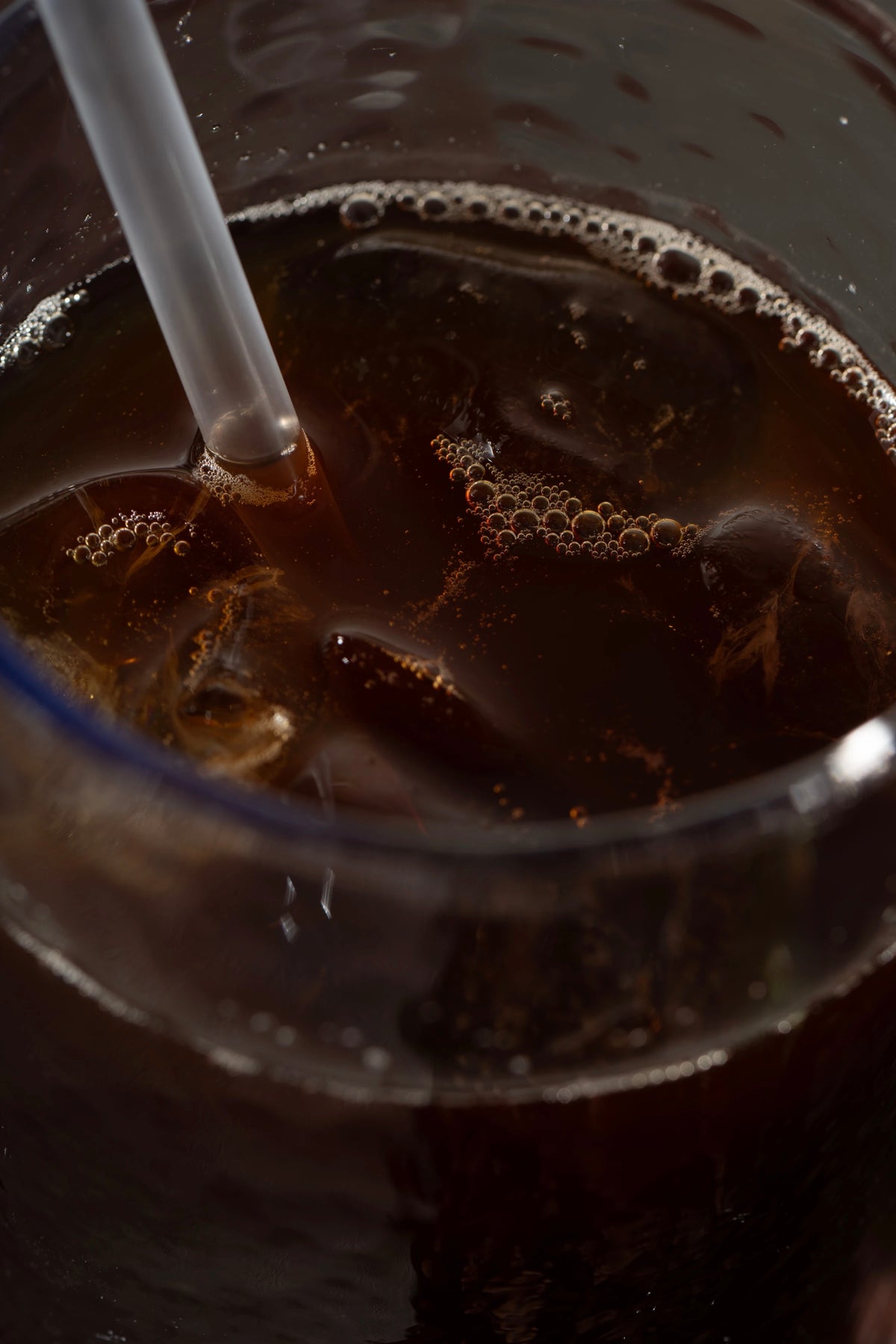 Iced Era coffee close-up with straw and bubbles