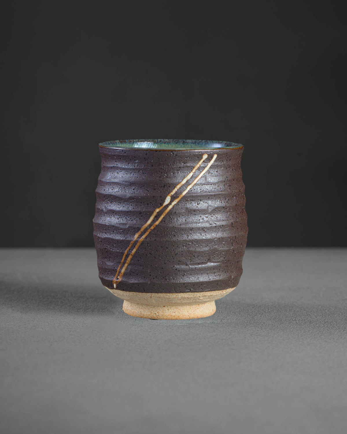 Yutaka Series Inazuma latte cup - dark ribbed glaze with cream lightning lines and teal interior, hand-glazed Mino ware from Japan
