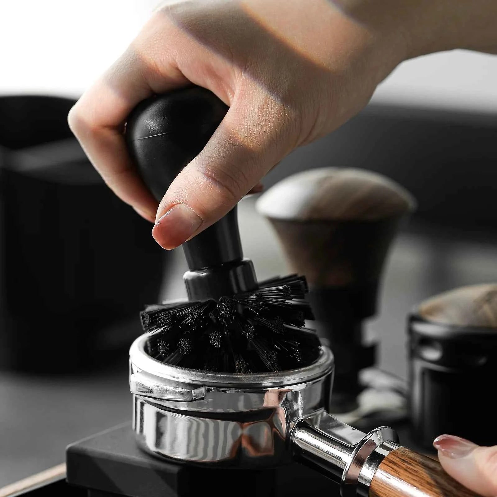 Brushing coffee grounds from a portafilter basket
