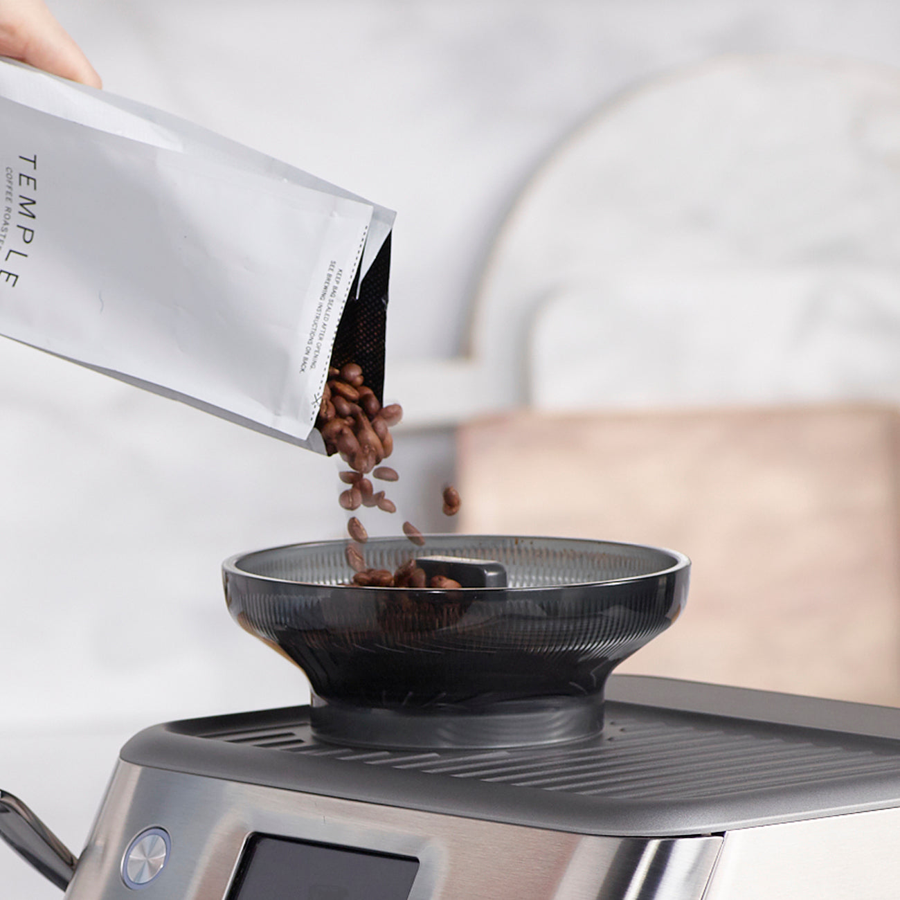 Loading beans into the Sage Barista Touch Impress hopper